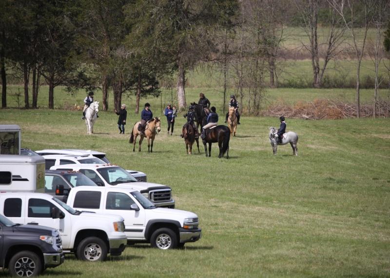 horses and riders in field at start of trail ride