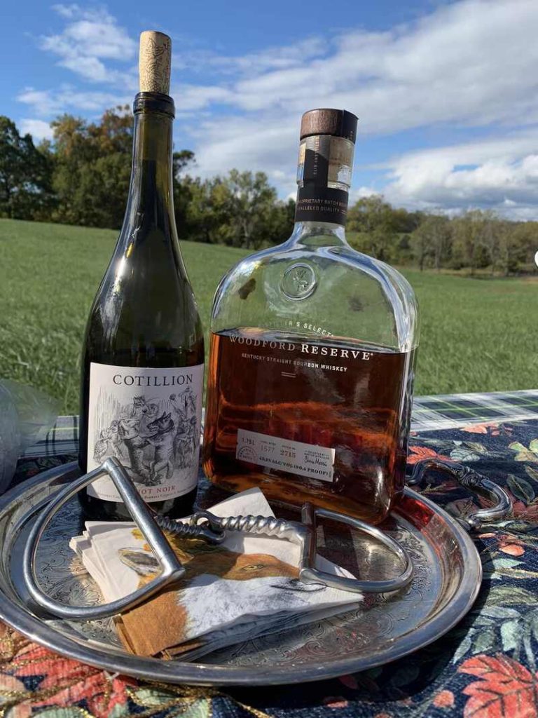 Wine and whiskey bottle on silver platter with bit