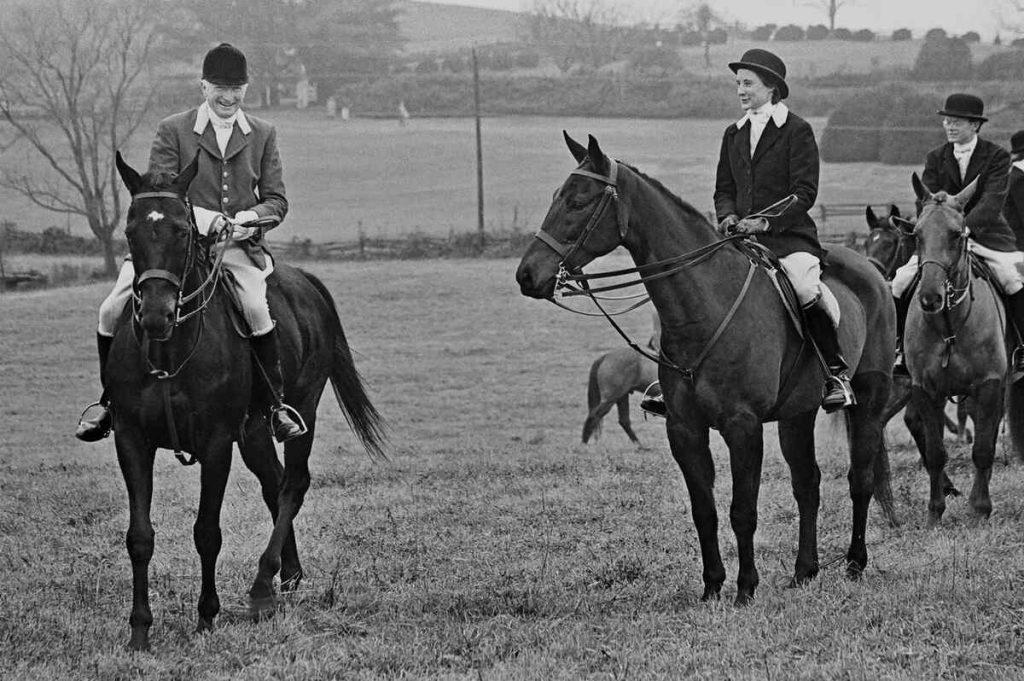 Mounted hunt riders in field