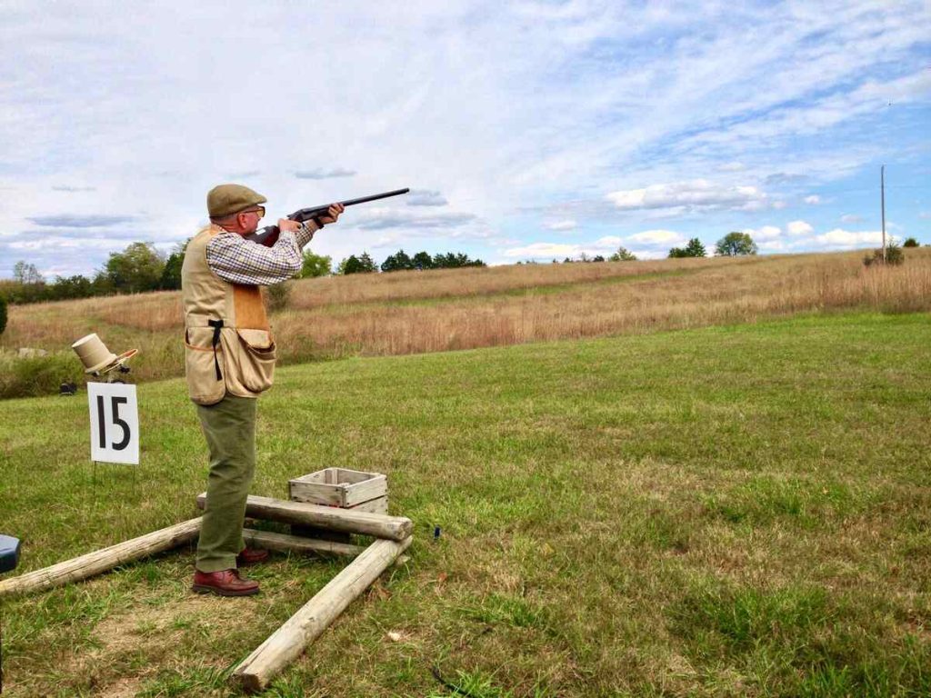 Man firing rifle