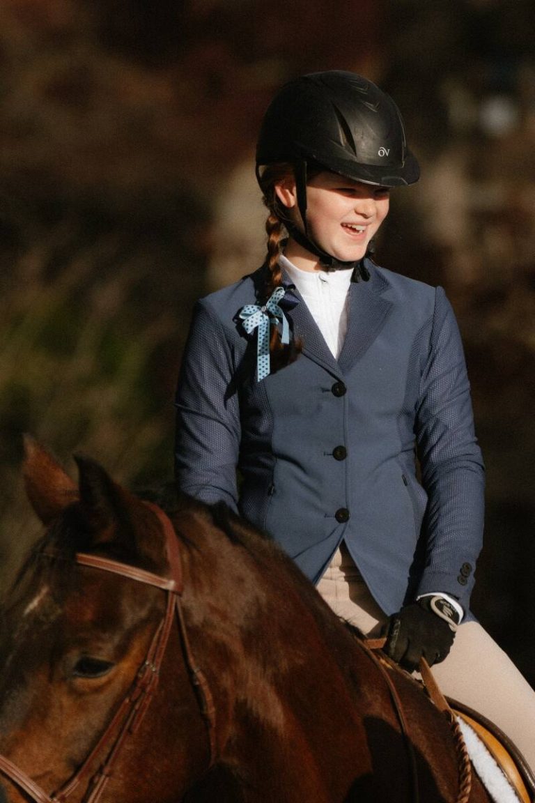 Girl on horseback in hunt attire