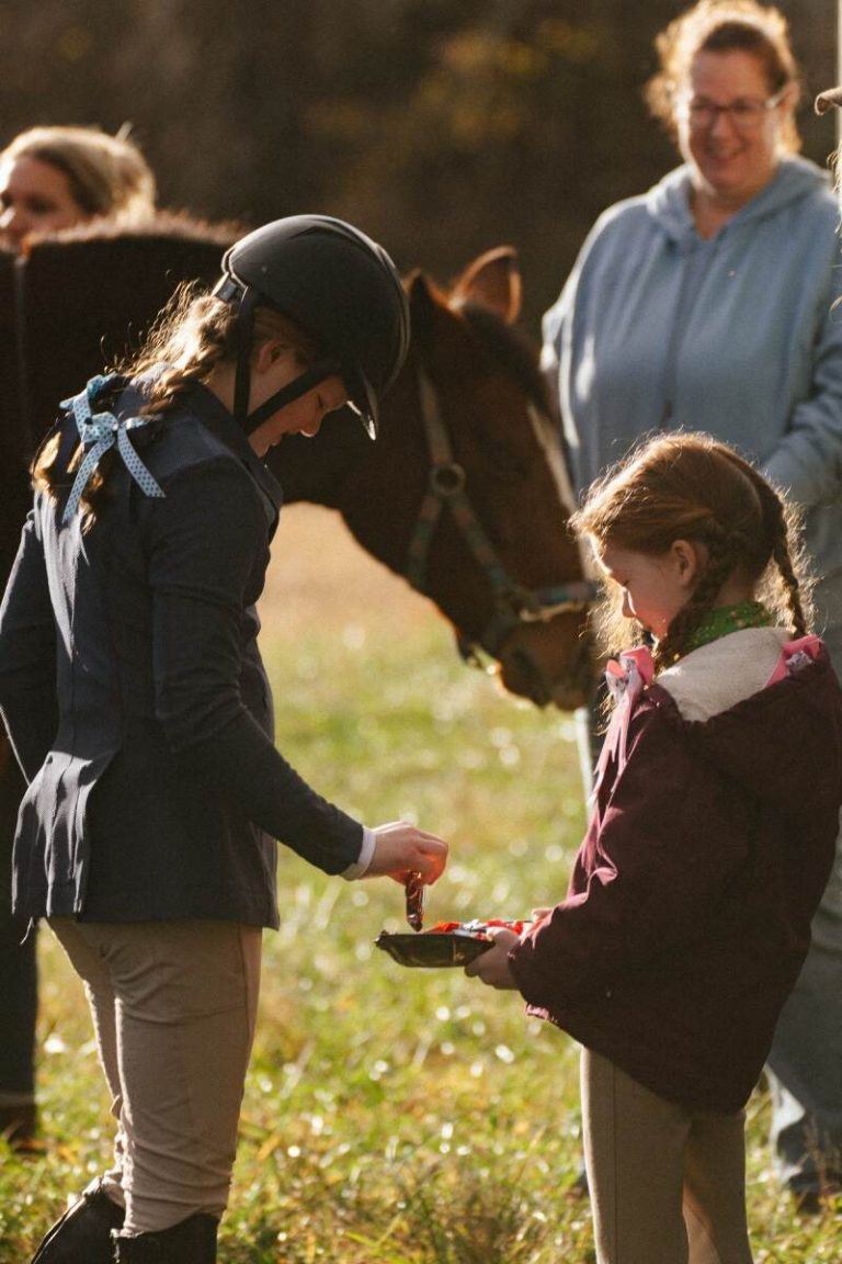 Girl dressed in hunt attire with smaller girl